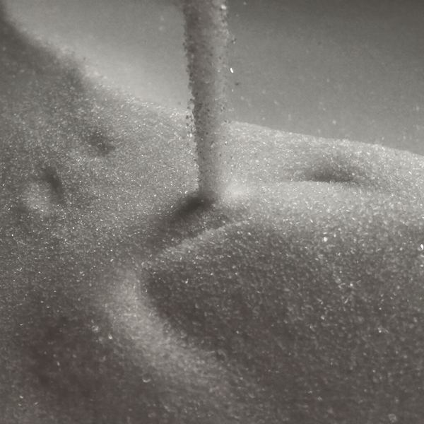 Granulated sugar pouring onto a heap